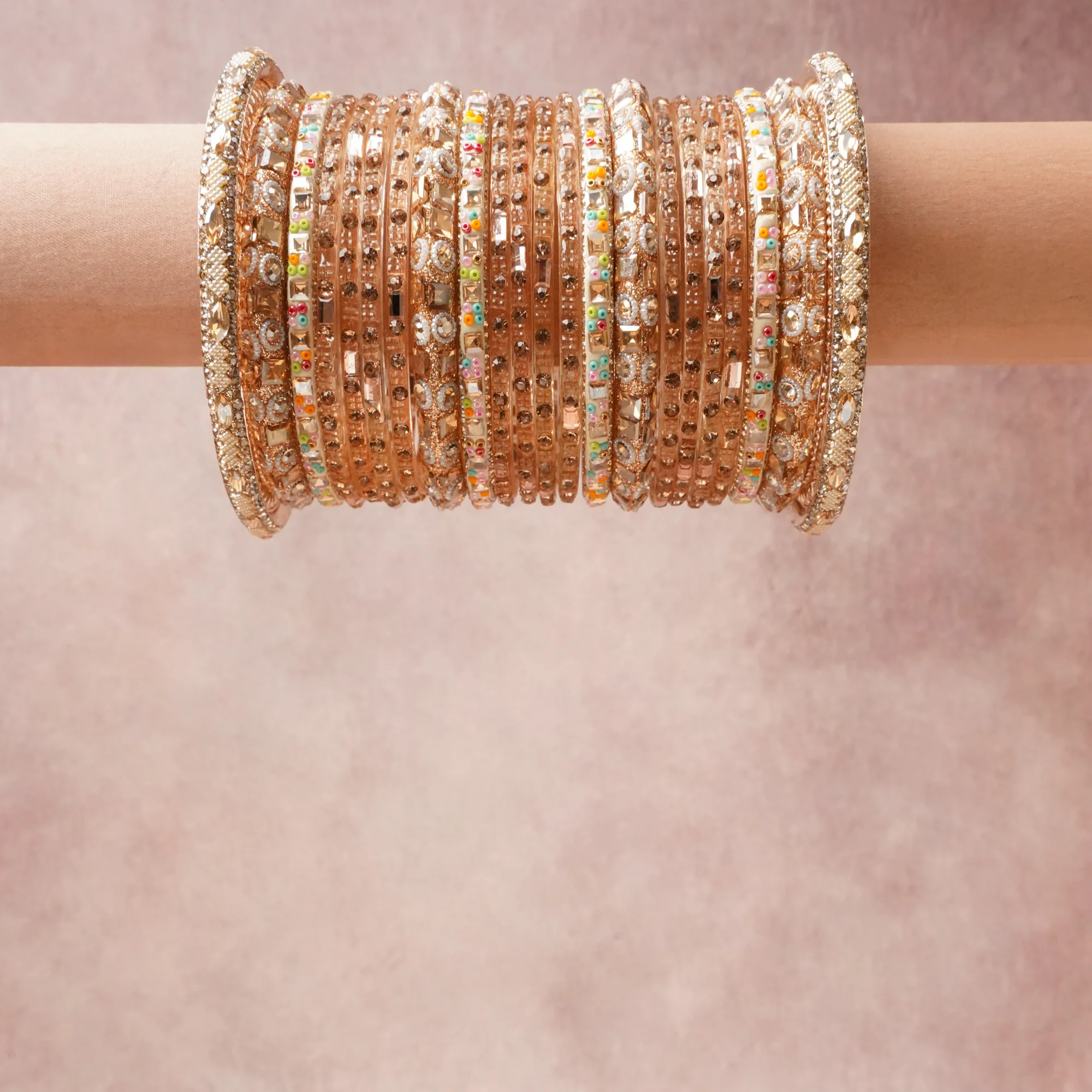 A grounding Gold forms the heart of the set, while touches of Clear, Pastel Pink, Pastel Blue, Pastel Green, Pastel Peach add charm.

A thoughtful composition of Gold-toned Metal, Glass, Crystal, Colored Glass/Resin, designed to feel complete without being heavy.
Each element layers seamlessly, creating a look that is refined, wearable and quietly striking.